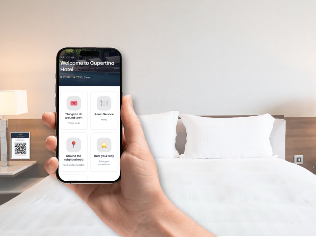 A guest holding a phone showing the branded hotel arrival page